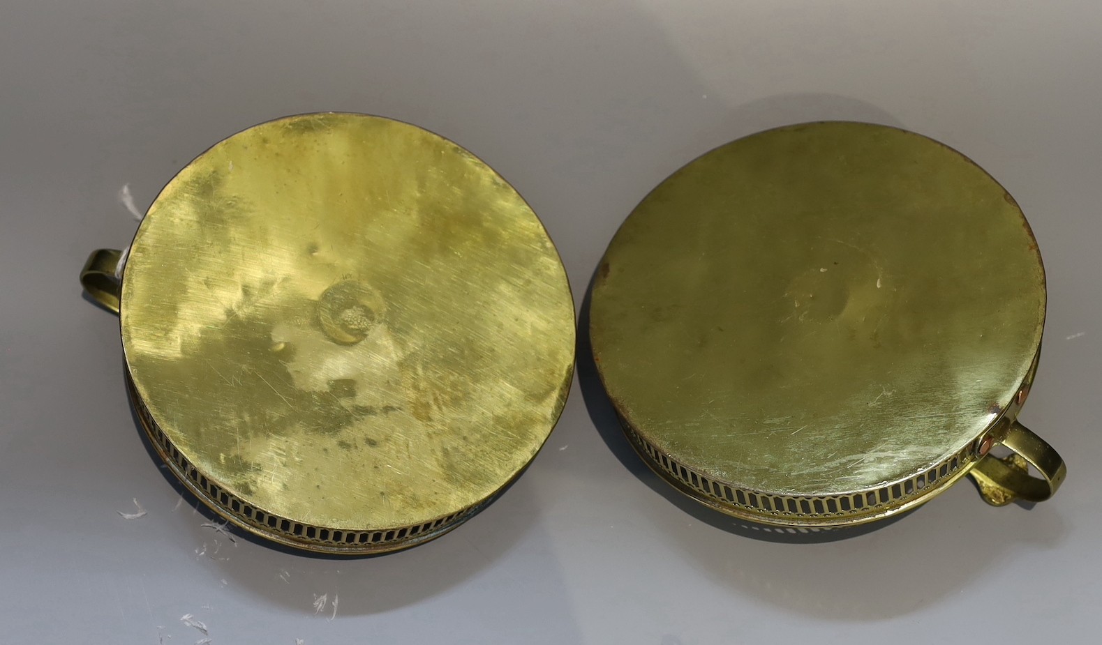 A pair of 19th century circular brass chambersticks, diameter 18cm